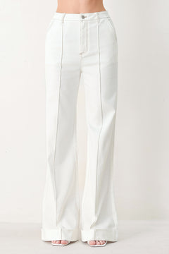Woman wearing white wide-leg pants with a seam down the middle of each leg | FREEMARKET