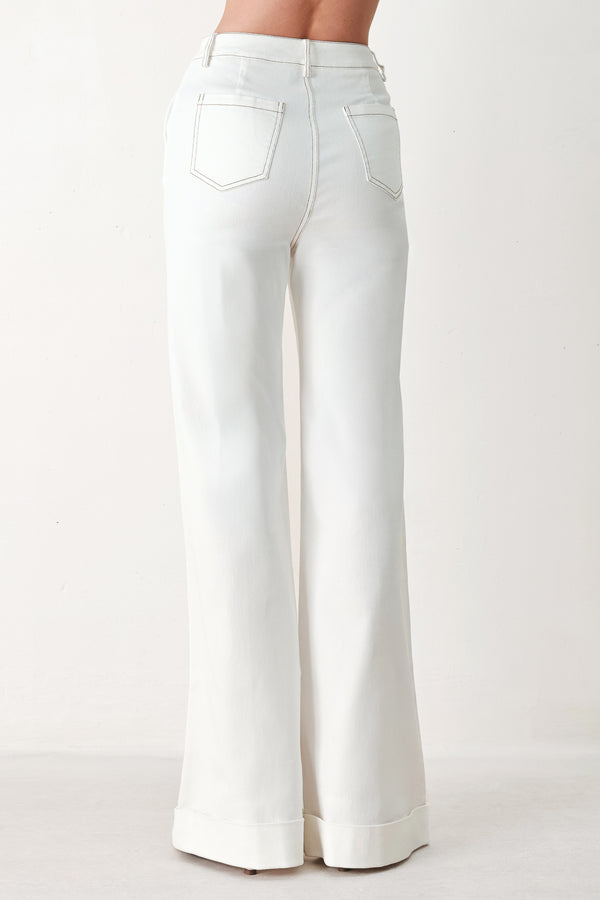 Woman wearing white wide-leg pants with a seam down the middle of each leg | FREEMARKET