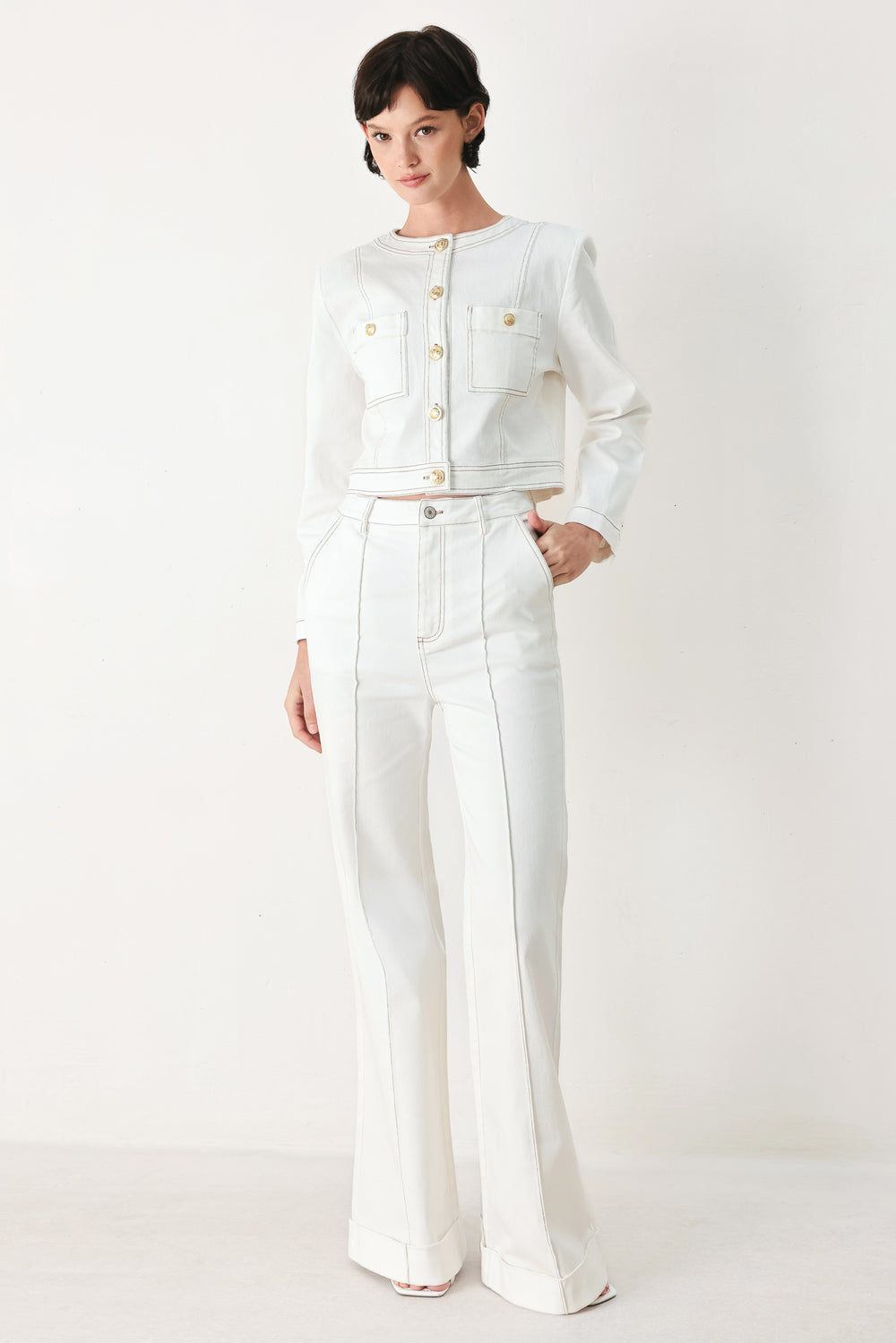 Woman wearing white wide-leg pants with a seam down the middle of each leg | FREEMARKET