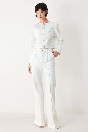 Woman wearing white wide-leg pants with a seam down the middle of each leg | FREEMARKET