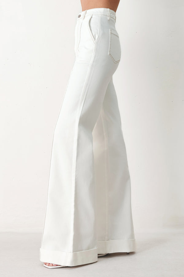 Woman wearing white wide-leg pants with a seam down the middle of each leg | FREEMARKET