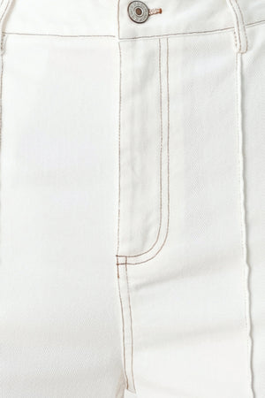 Woman wearing white wide-leg pants with a seam down the middle of each leg | FREEMARKET