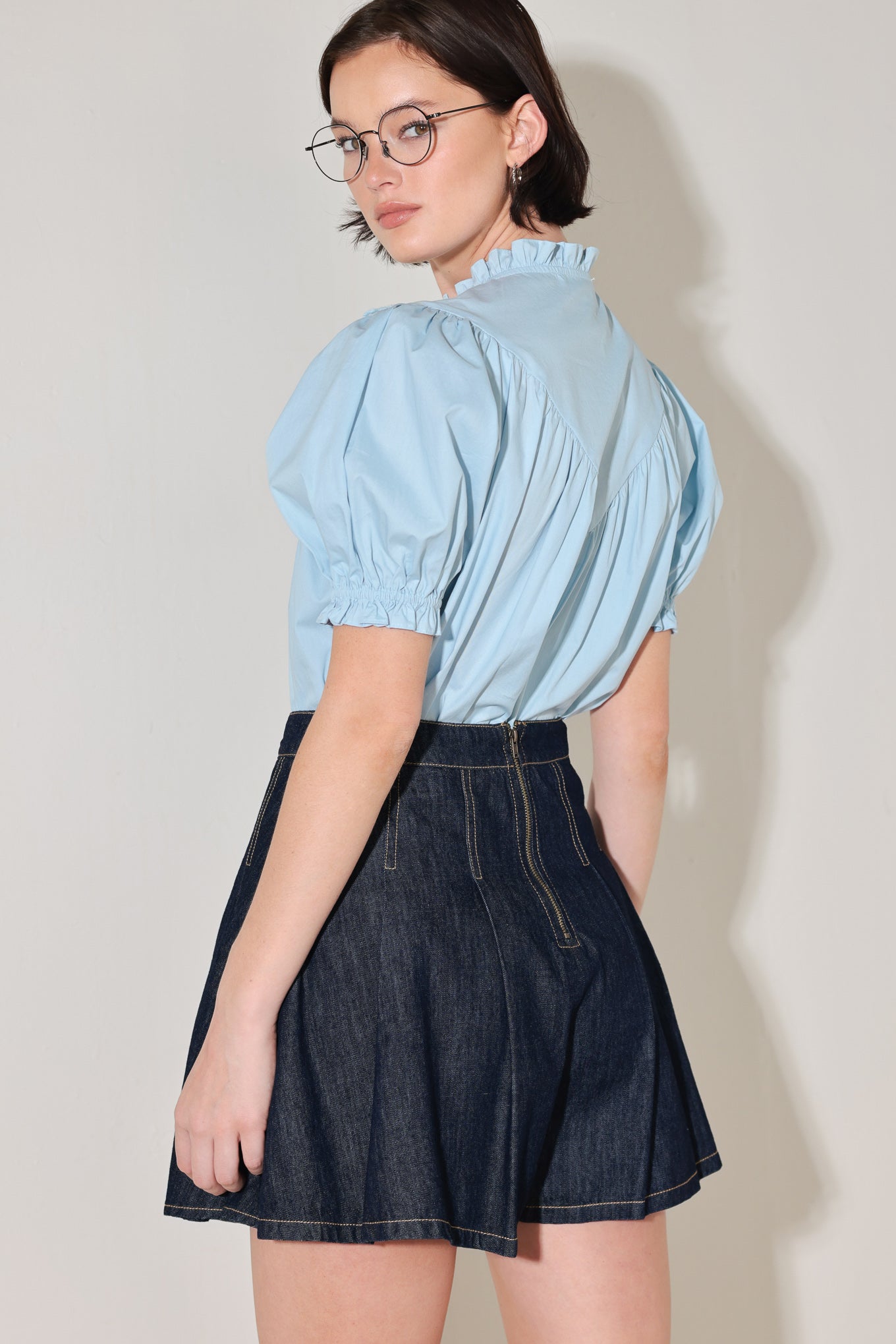 
A denim skort with knife pleats and back zipper closure

Details:

Self : 100% Cotton

Size &amp; Fit

- Model is 5`8" And Wearing Size Small
- Measurements Taken From Size Small
- Approx. Length: 17"