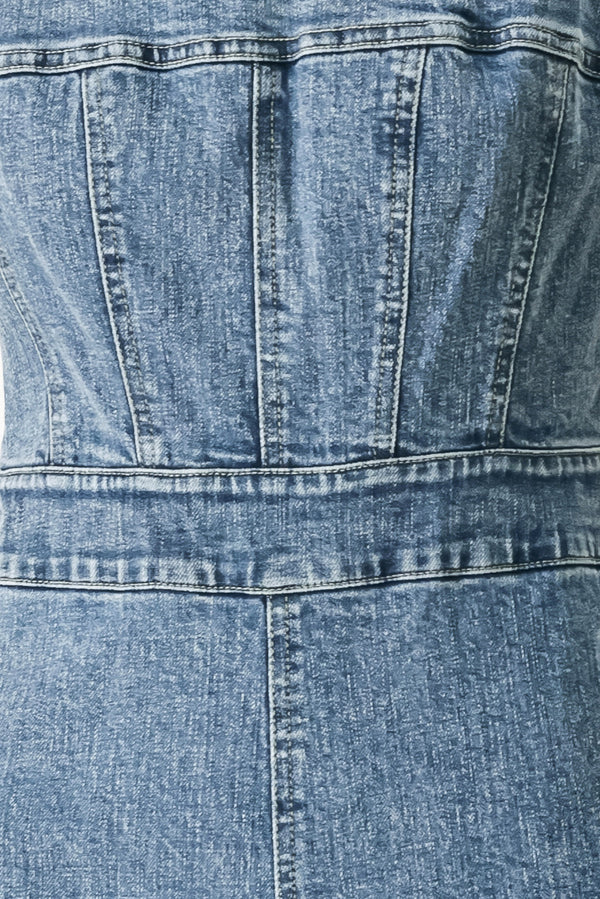 Close up of a denim jumpsuit featuring straight neckline, straps, wide leg and back zipper closure | FREEMARKET