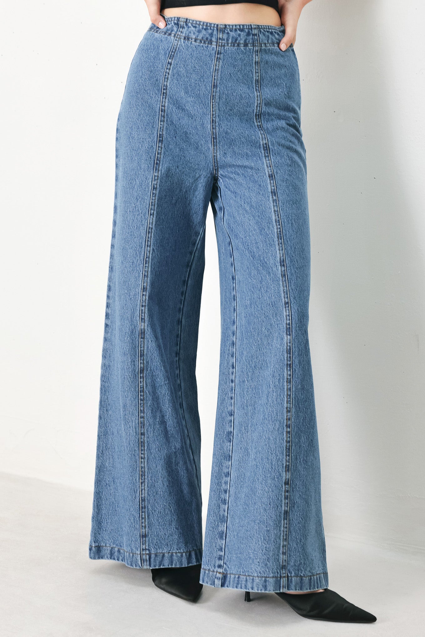 A washed denim pant with elastic waist and wide leg. 