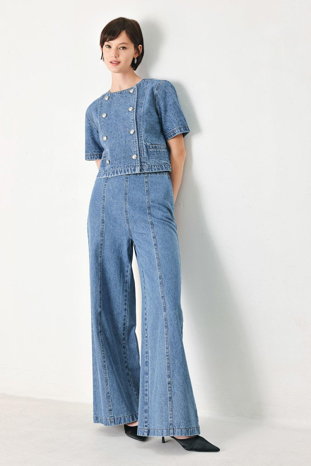 A washed denim pant with elastic waist and wide leg. 