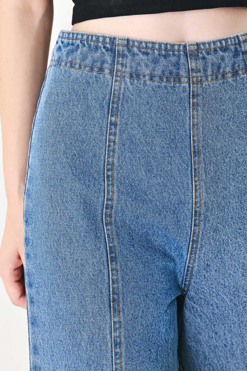 A washed denim pant with elastic waist and wide leg. 