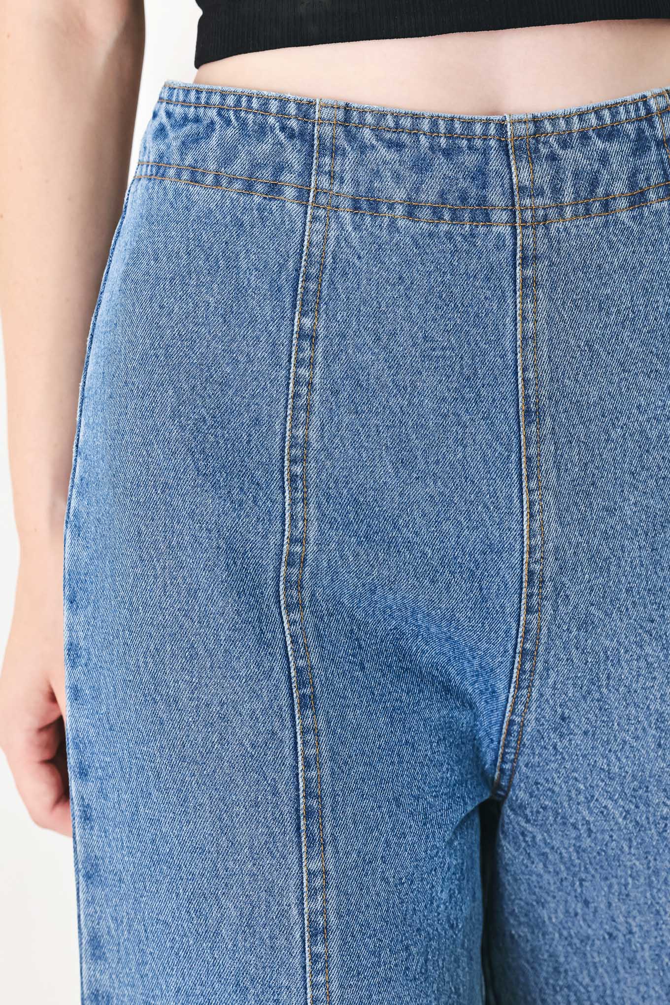 A washed denim pant with elastic waist and wide leg. 