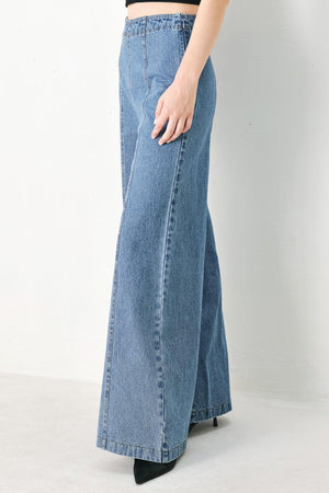A washed denim pant with elastic waist and wide leg. 