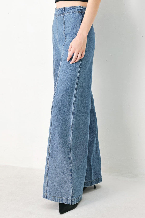 A washed denim pant with elastic waist and wide leg. 