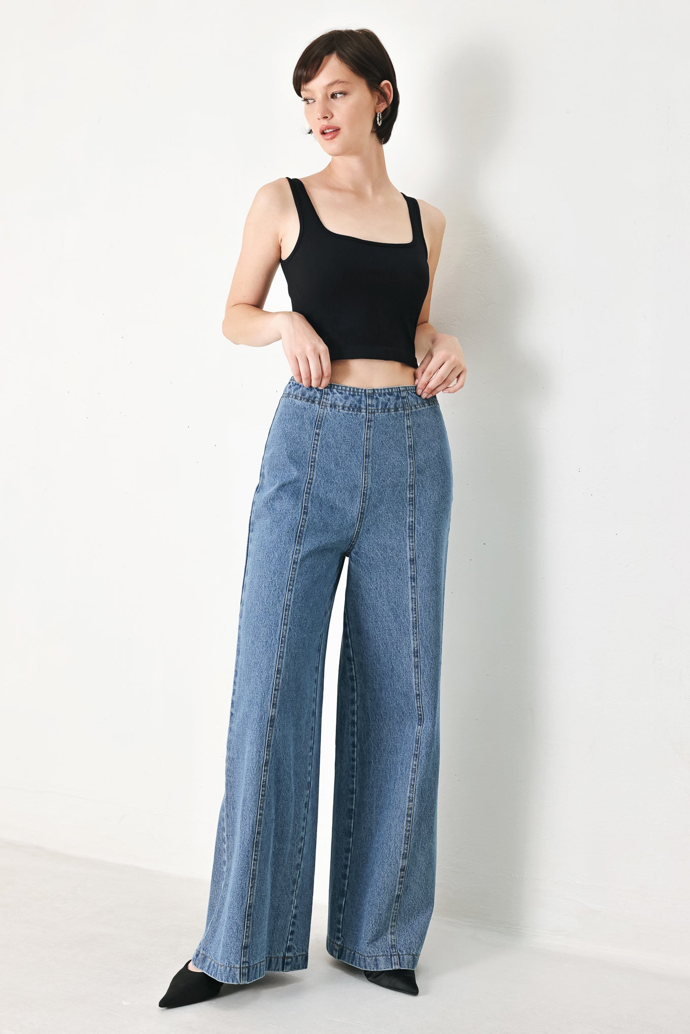 A washed denim pant with elastic waist and wide leg. 