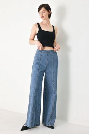 A washed denim pant with elastic waist and wide leg. 