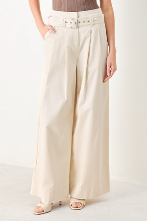 Woman wearing beige wide-leg pants with self belt, front closure and pockets | FREEMARKET | Flying Tomato