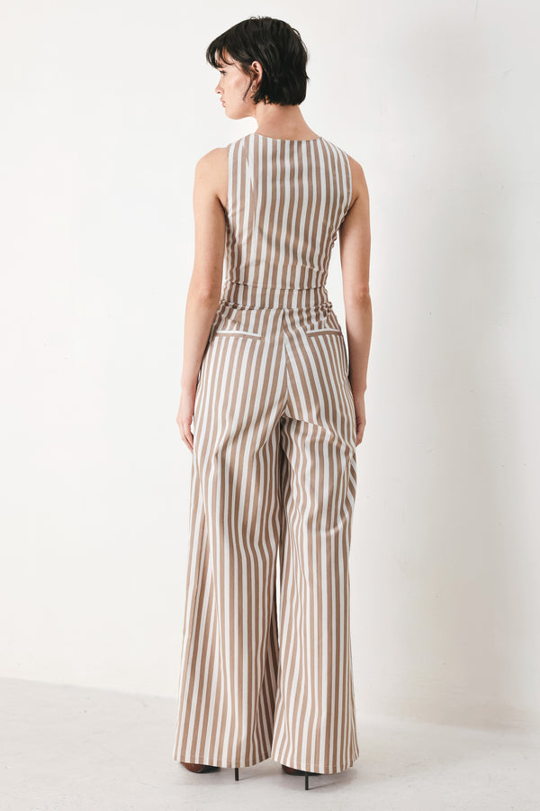 Woman wearing a striped woven jumpsuit featuring V neckline, sleeveless, front button/zipper closure and wide leg | FREEMARKET