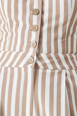 Close up of a striped woven jumpsuit featuring V neckline, sleeveless, front button/zipper closure and wide leg | FREEMARKET