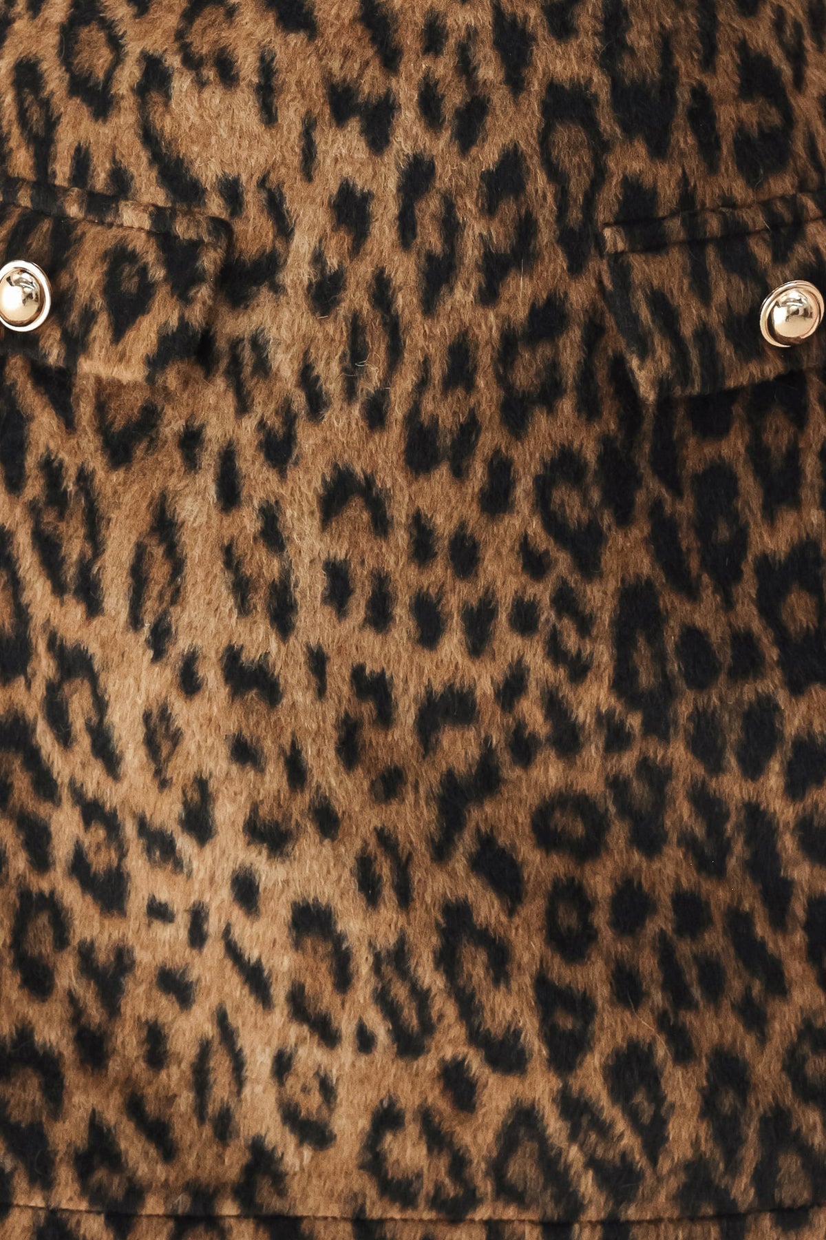 A model wearing a brown leopard-print mini skirt with two front button details | FREEMARKET
