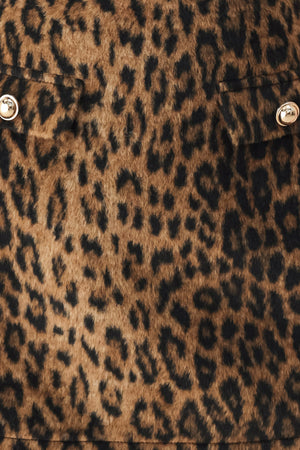 A model wearing a brown leopard-print mini skirt with two front button details | FREEMARKET