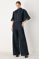 Woman wearing dark denim wide-leg pants with front closure, self belt | FREEMARKET