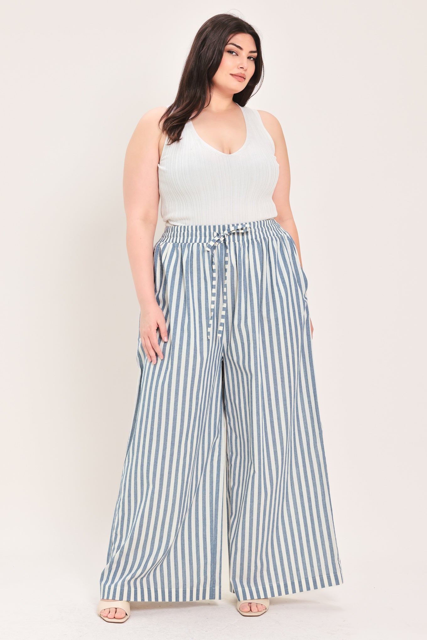 Woman wearing striped woven pant featuring front pleat, side pockets, wide leg and elastic back waistband | FREEMARKET