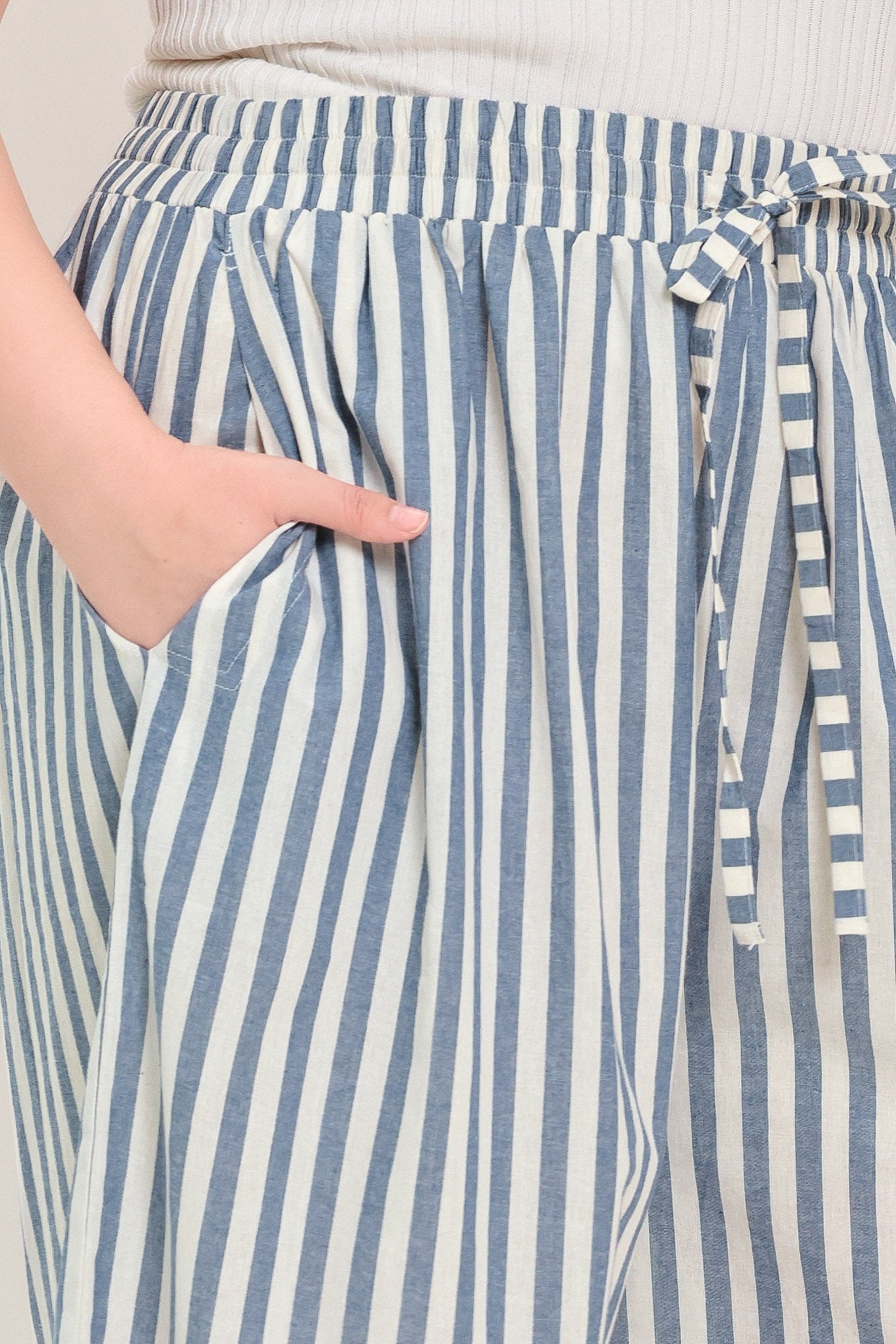 Woman wearing striped woven pant featuring front pleat, side pockets, wide leg and elastic back waistband | FREEMARKET