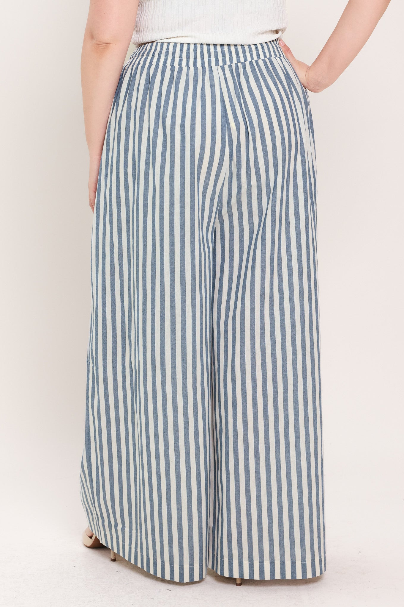 Woman wearing striped woven pant featuring front pleat, side pockets, wide leg and elastic back waistband | FREEMARKET