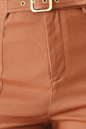 Close-up of terracotta pants with a metal buckle | FREEMARKET | Flying Tomato