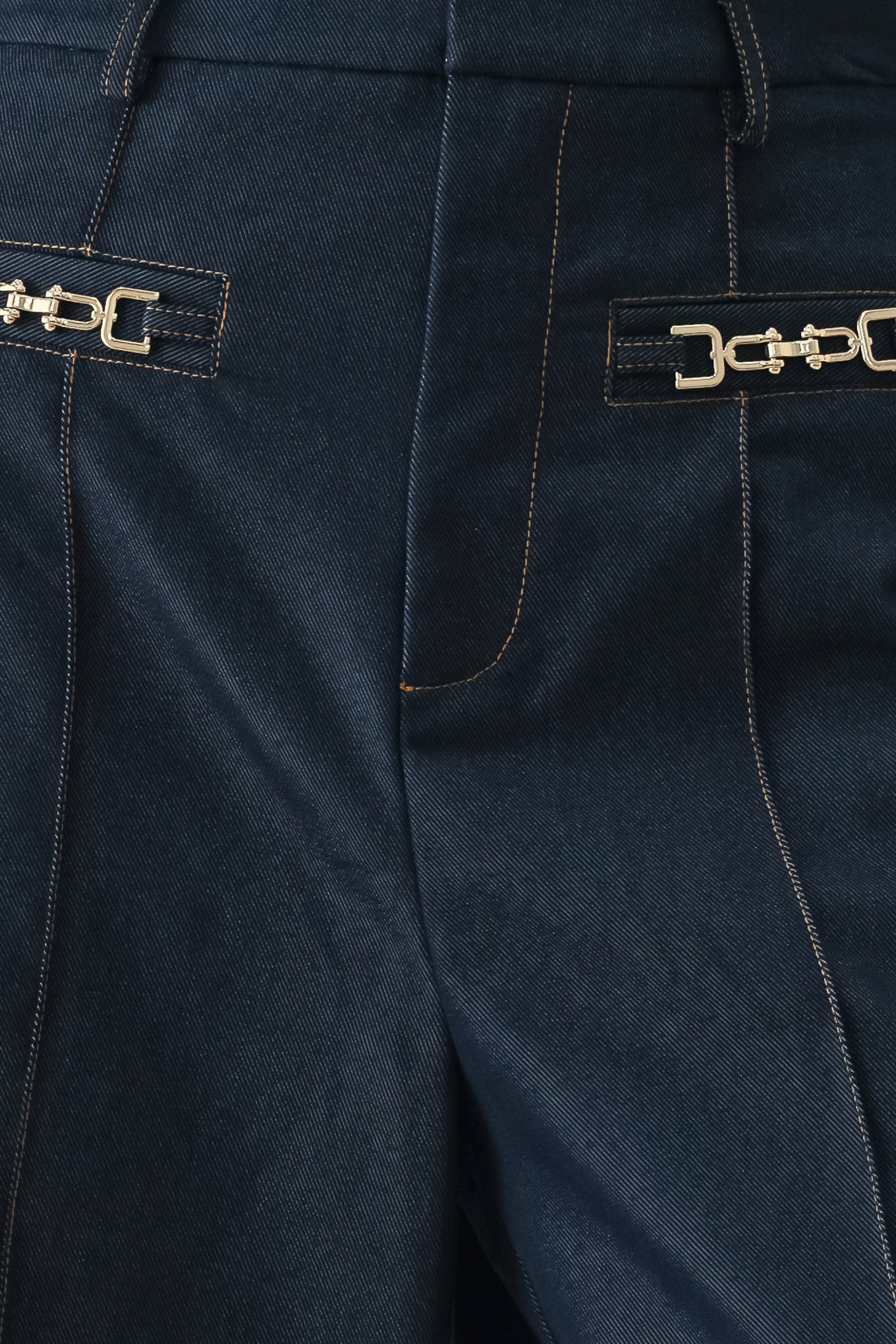 Woman wearing navy blue wide-leg pants with gold belt details | FREEMARKET