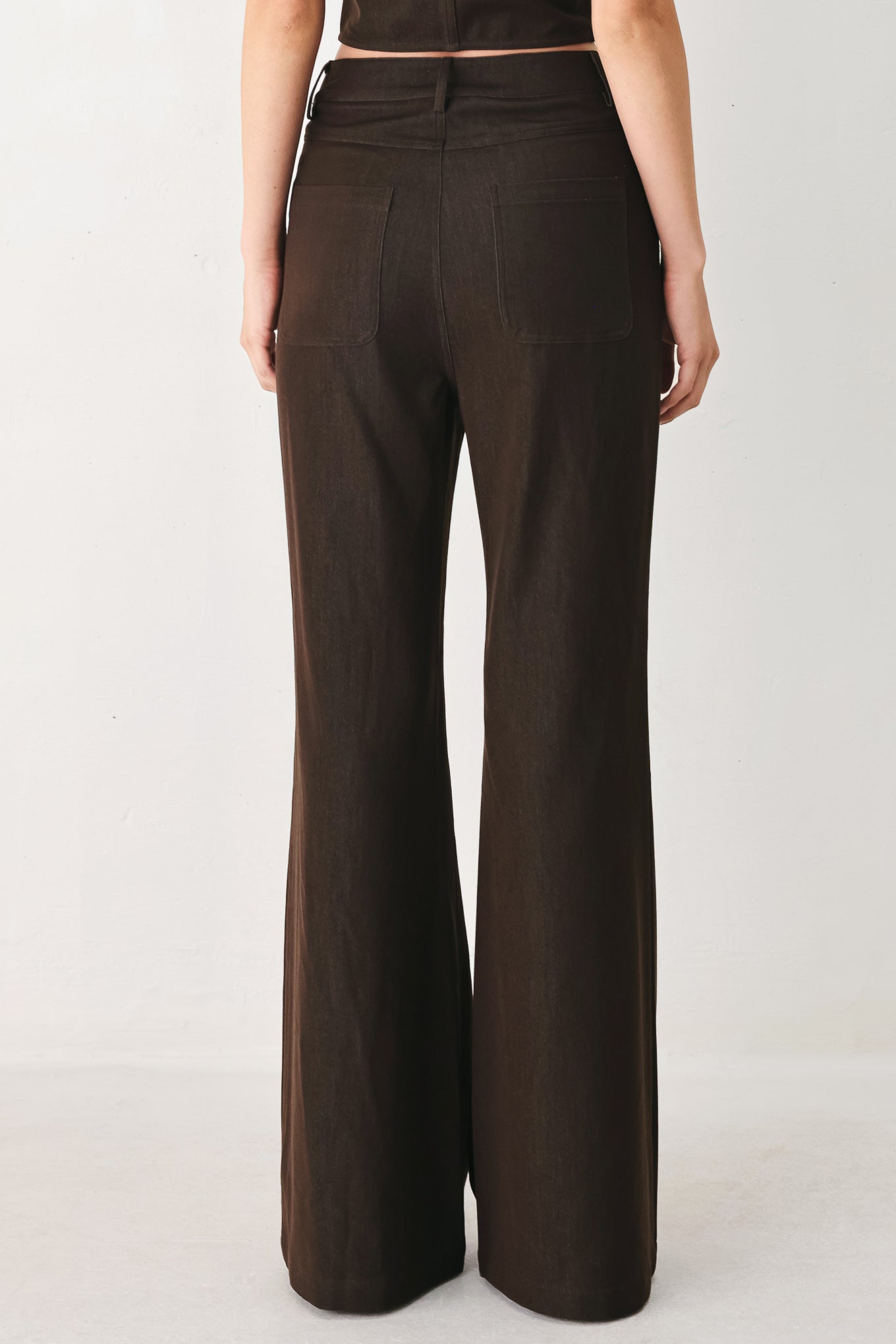 Woman wearing brown flared pants | FREEMARKET