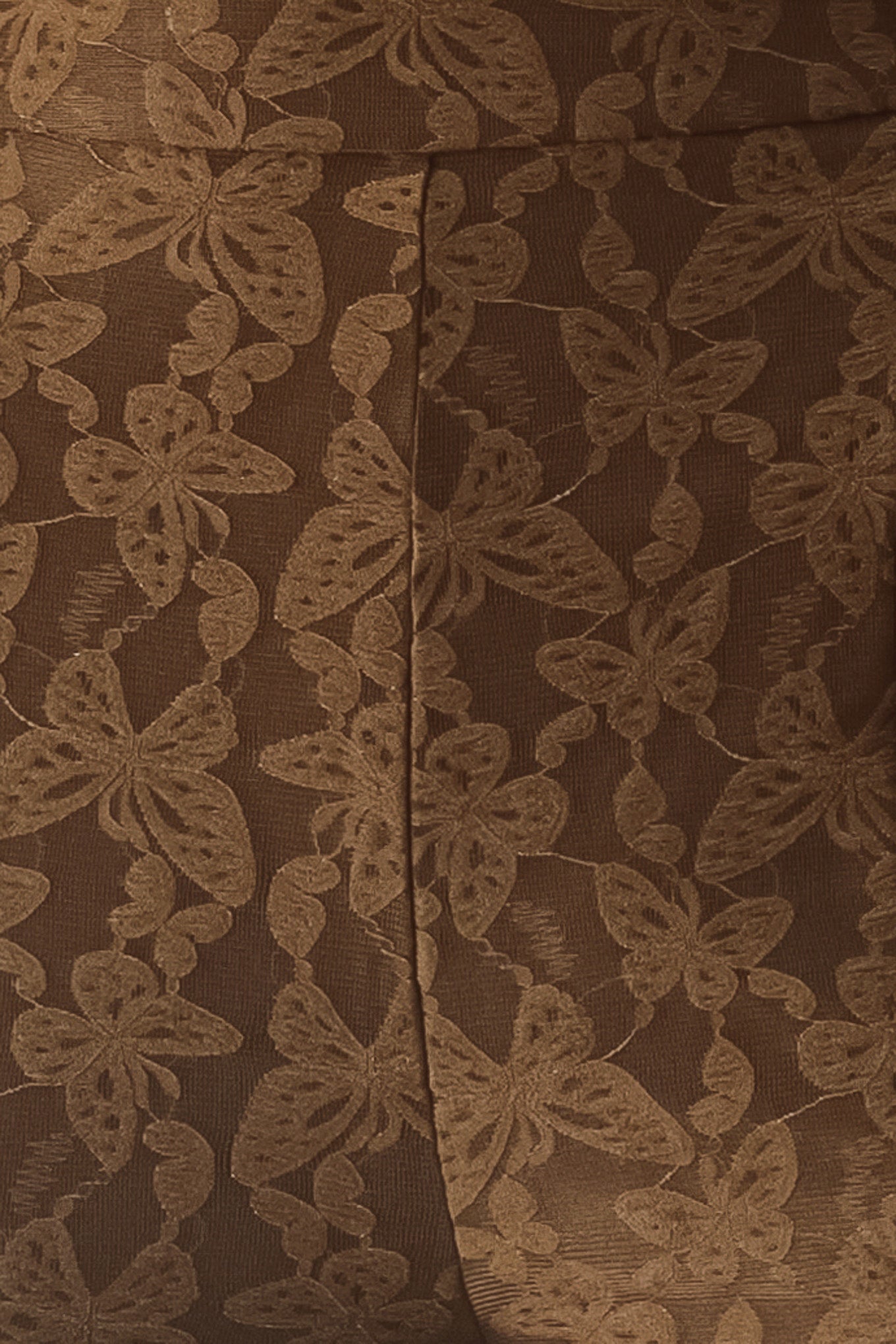 Close up of brown patterned bell-bottom pants with flare leg and back zipper closure | FREEMARKET