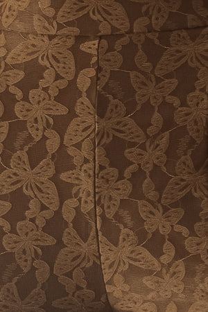 Close up of brown patterned bell-bottom pants with flare leg and back zipper closure | FREEMARKET