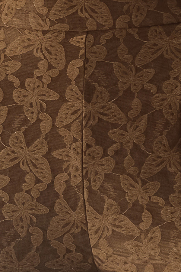 Close up of brown patterned bell-bottom pants with flare leg and back zipper closure | FREEMARKET