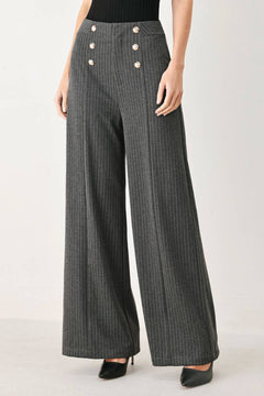 Woman wearing high-waisted, wide-leg charcoal gray and white pinstriped trousers with decorative gold-tone buttons on the front waistband | FREEMARKET