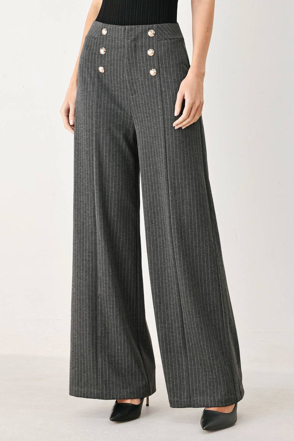 Woman wearing high-waisted, wide-leg charcoal gray and white pinstriped trousers with decorative gold-tone buttons on the front waistband | FREEMARKET