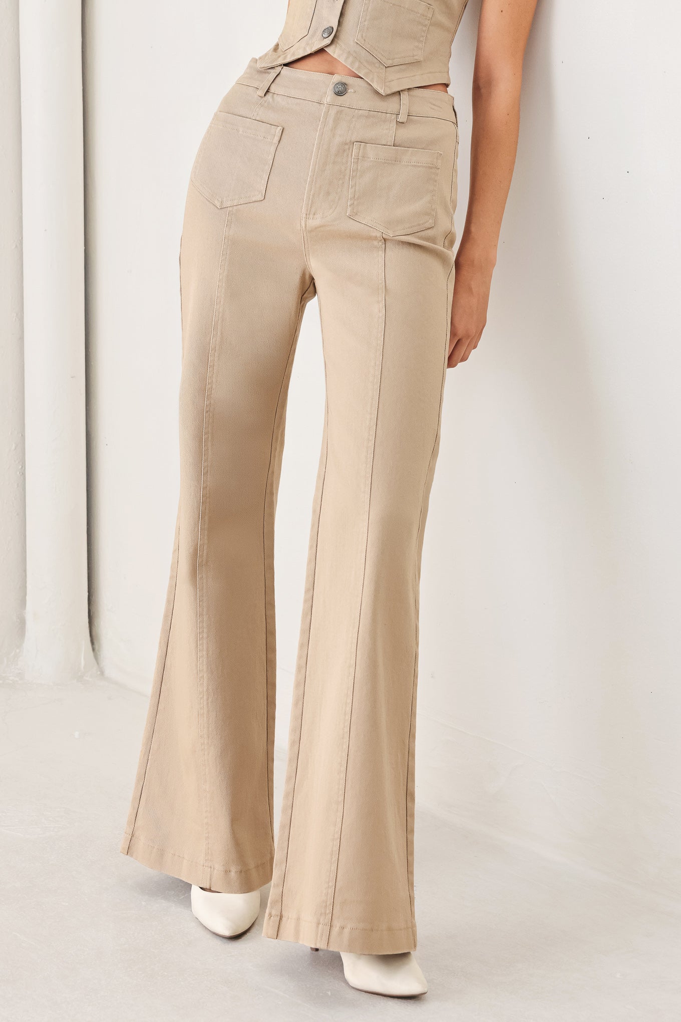 Woman wearing taupe beige flared pants with front pockets | FREEMARKET