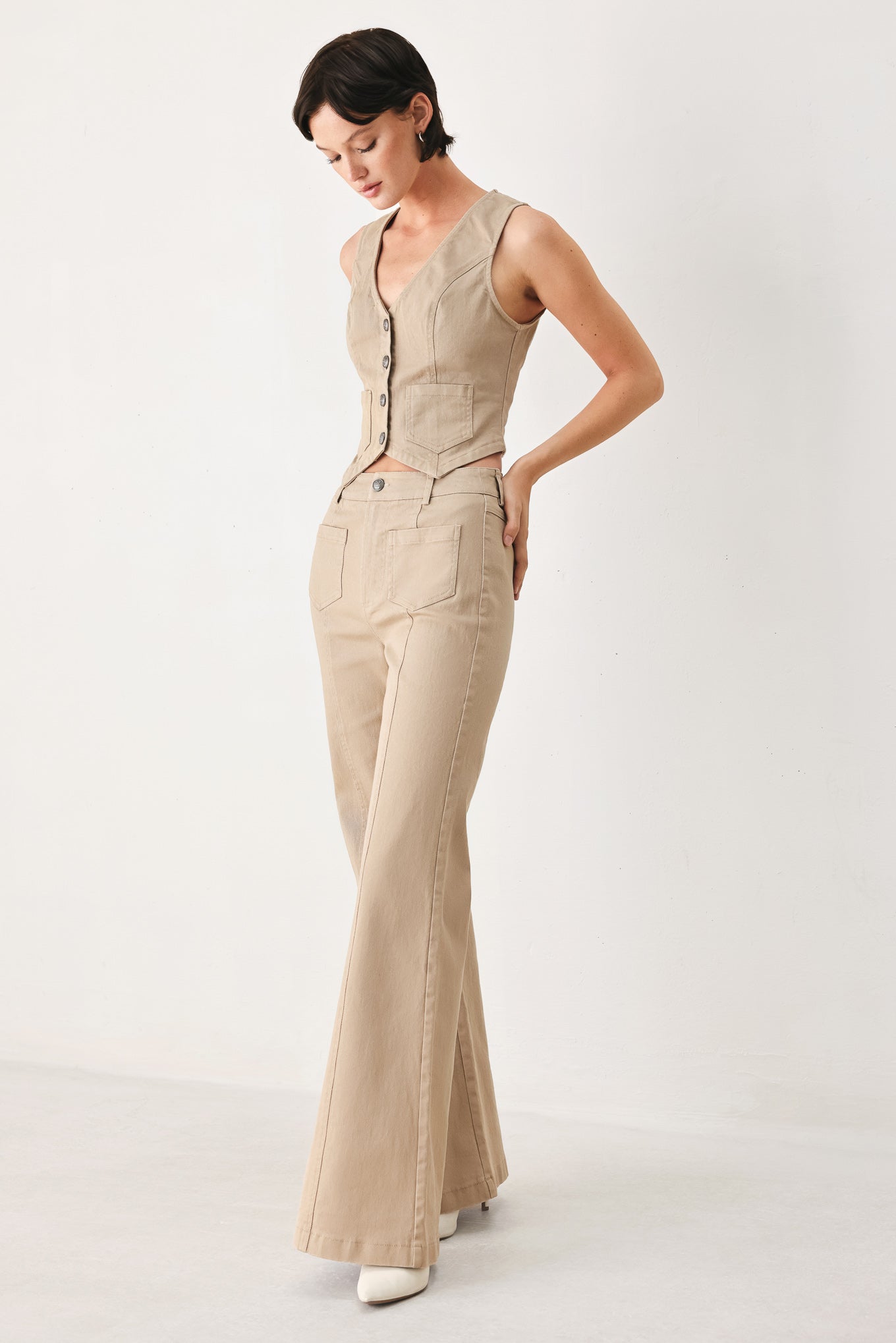 Woman wearing taupe beige flared pants with front pockets | FREEMARKET