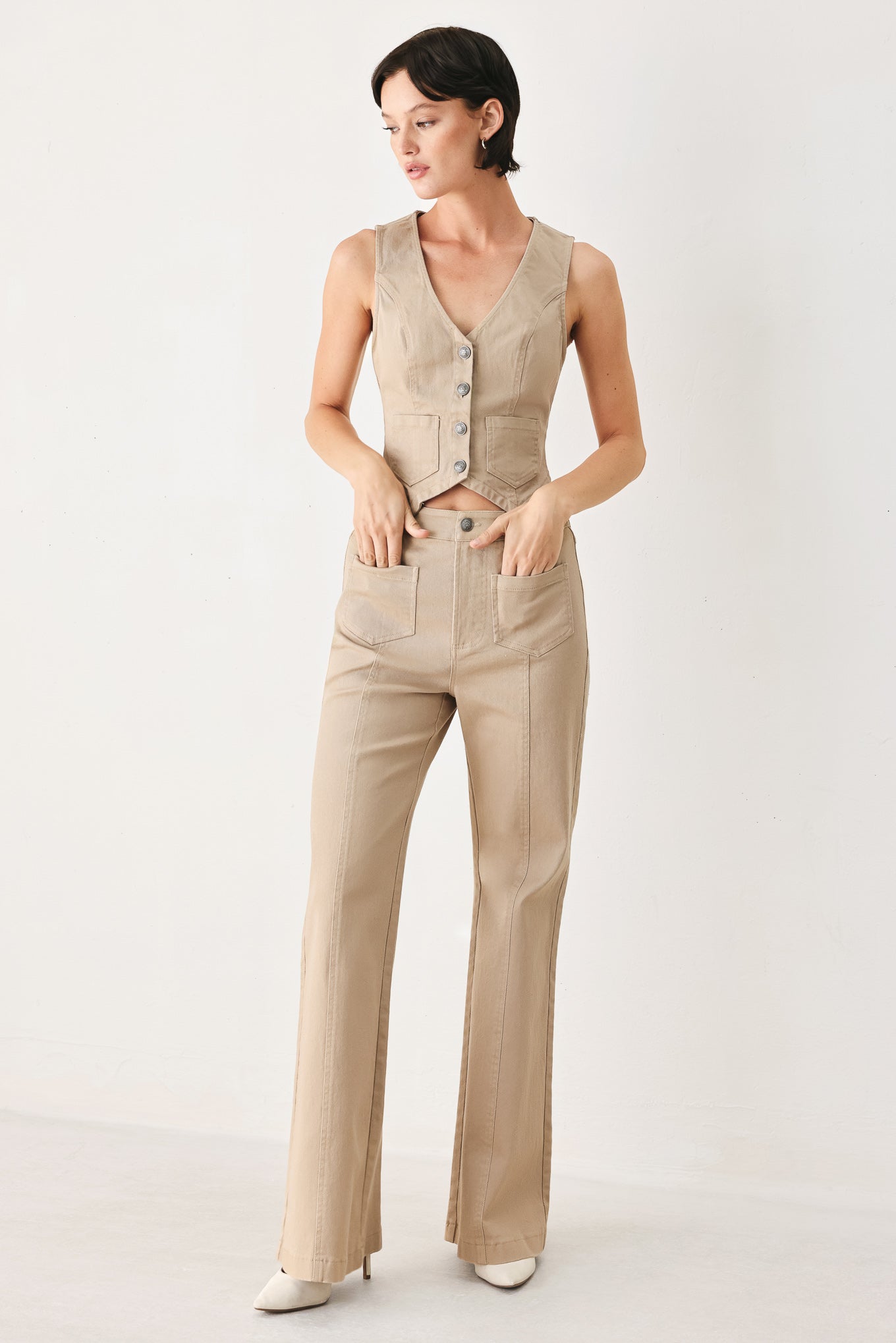 Woman wearing taupe beige flared pants with front pockets | FREEMARKET