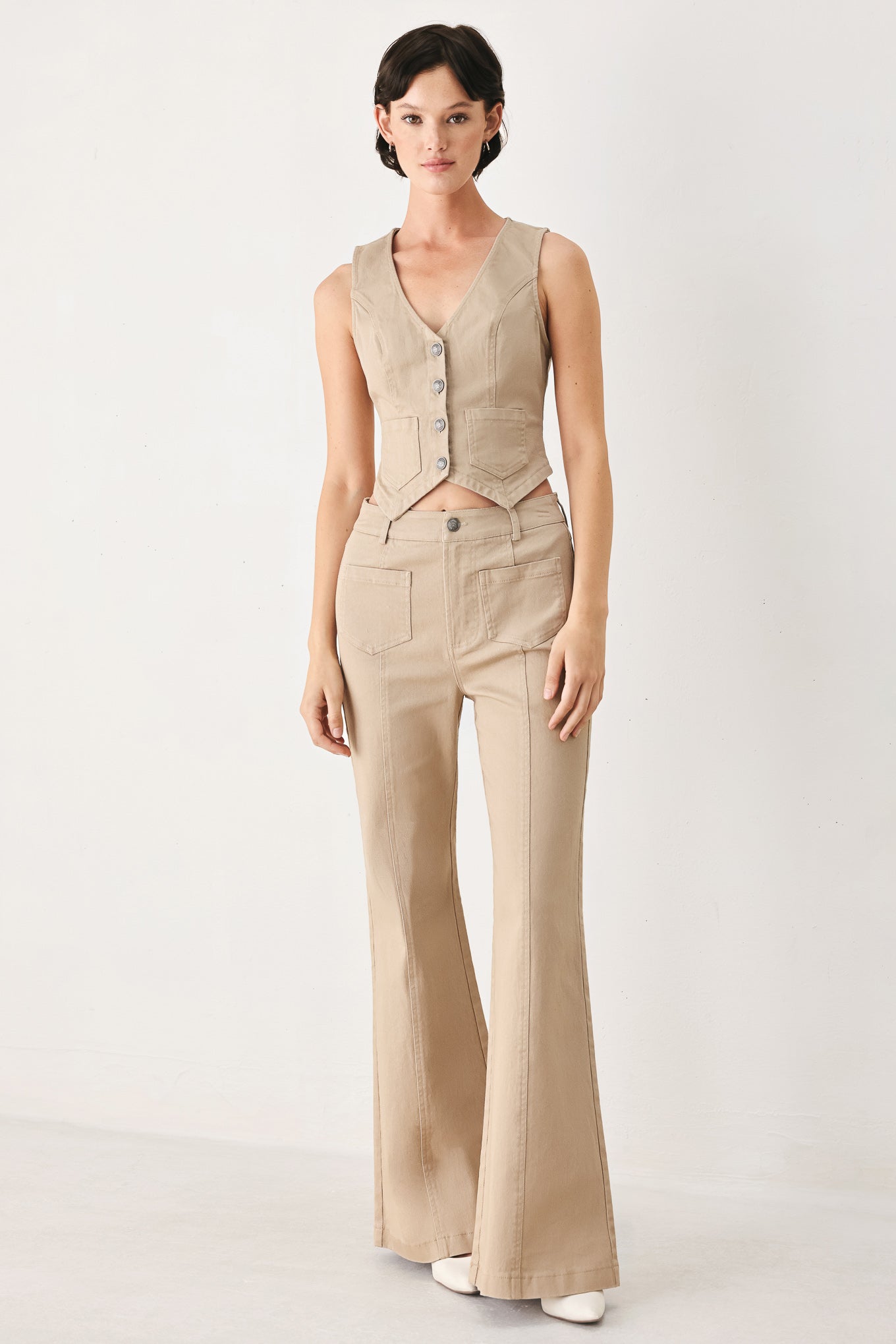 Woman wearing taupe beige flared pants with front pockets | FREEMARKET