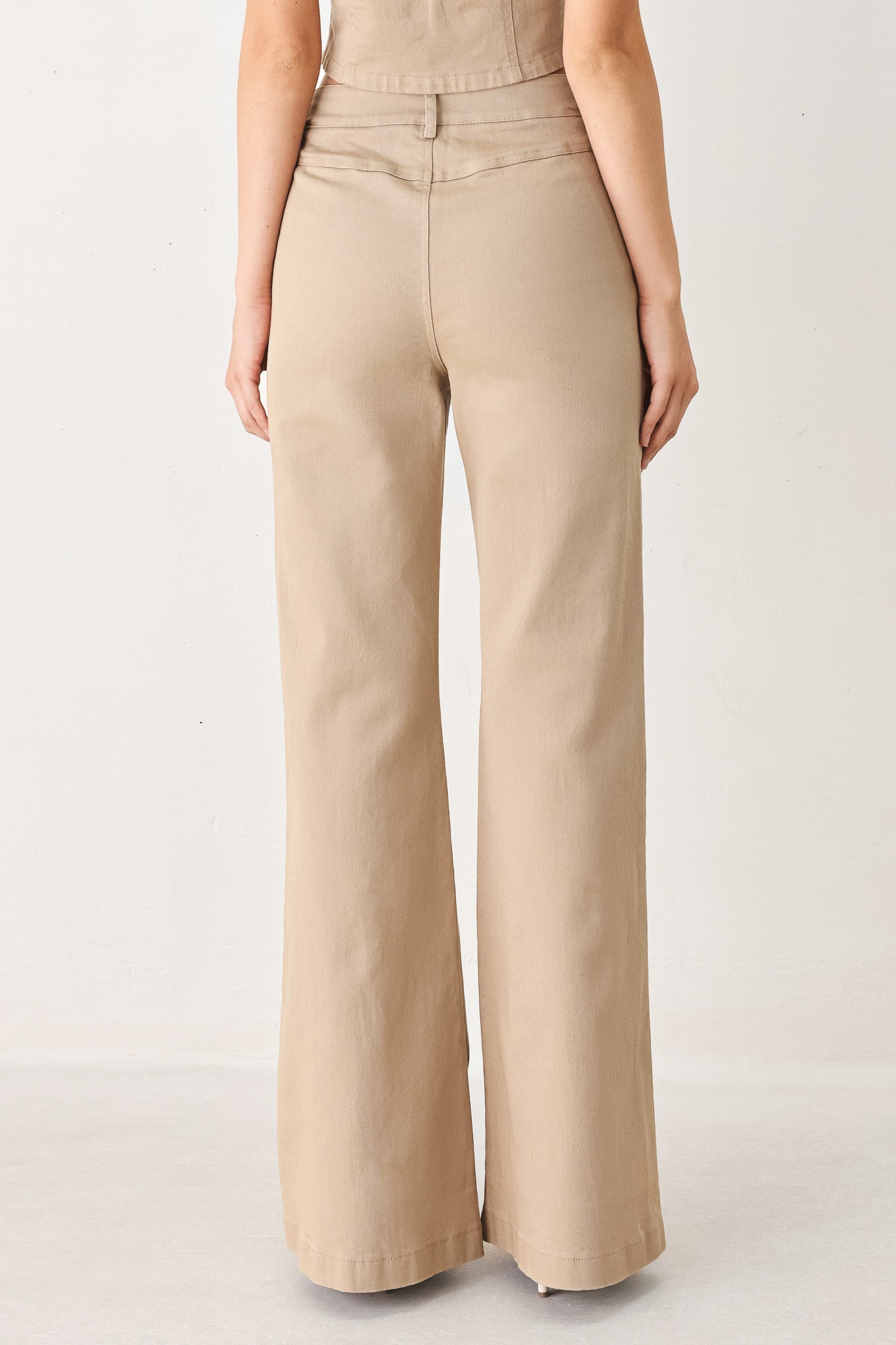 Woman wearing taupe beige flared pants with front pockets | FREEMARKET