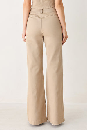 Woman wearing taupe beige flared pants with front pockets | FREEMARKET