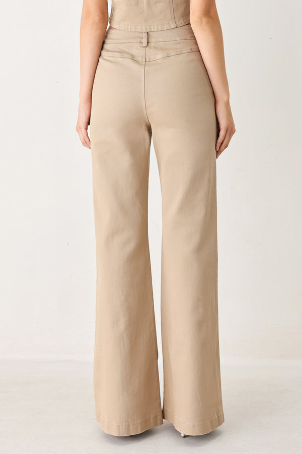 Woman wearing taupe beige flared pants with front pockets | FREEMARKET