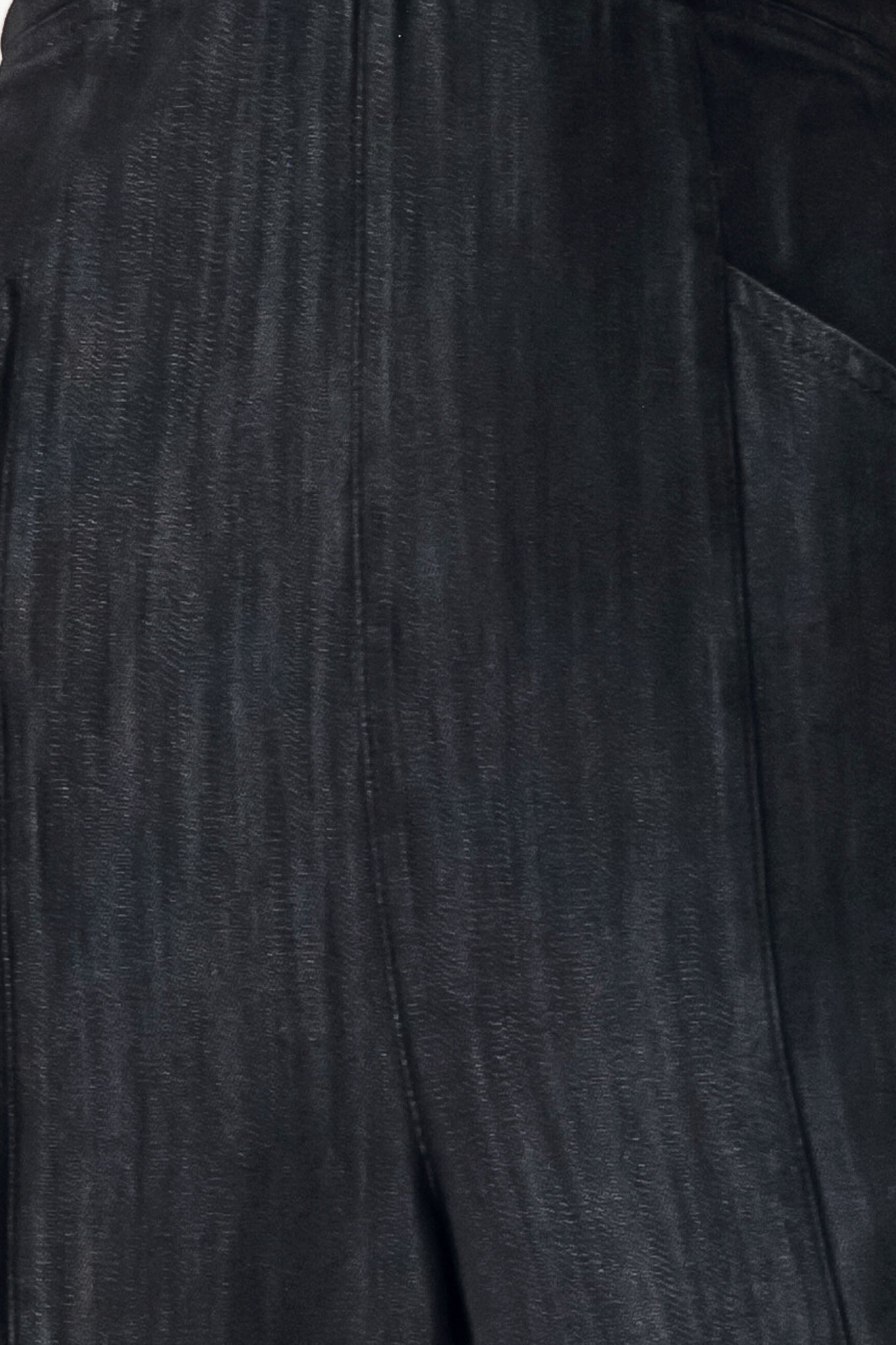 Woman wearing a black denim jumpsuit featuring halter neckline with plunging V and hardware, pockets, wide leg, bare back with cross straps and zipper closure | FREEMARKET