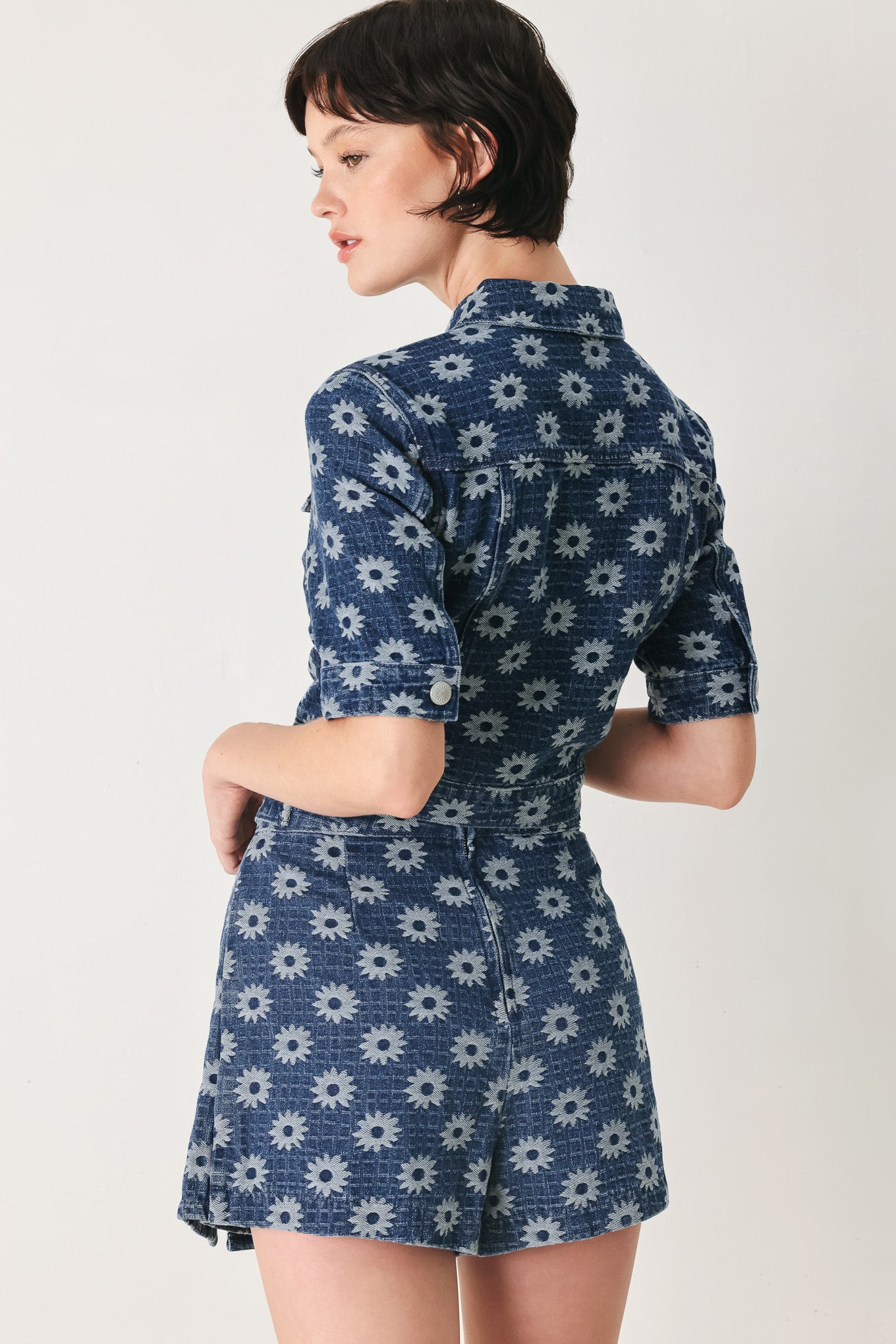 Woman wearing a jacquard blue denim skort with side tab front side slit and back zipper closure | FREEMARKET