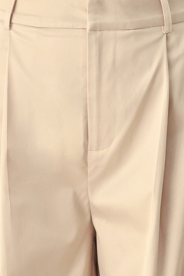 A person wearing high-waisted, wide-leg champagne trousers with a glossy finish | FREEMARKET