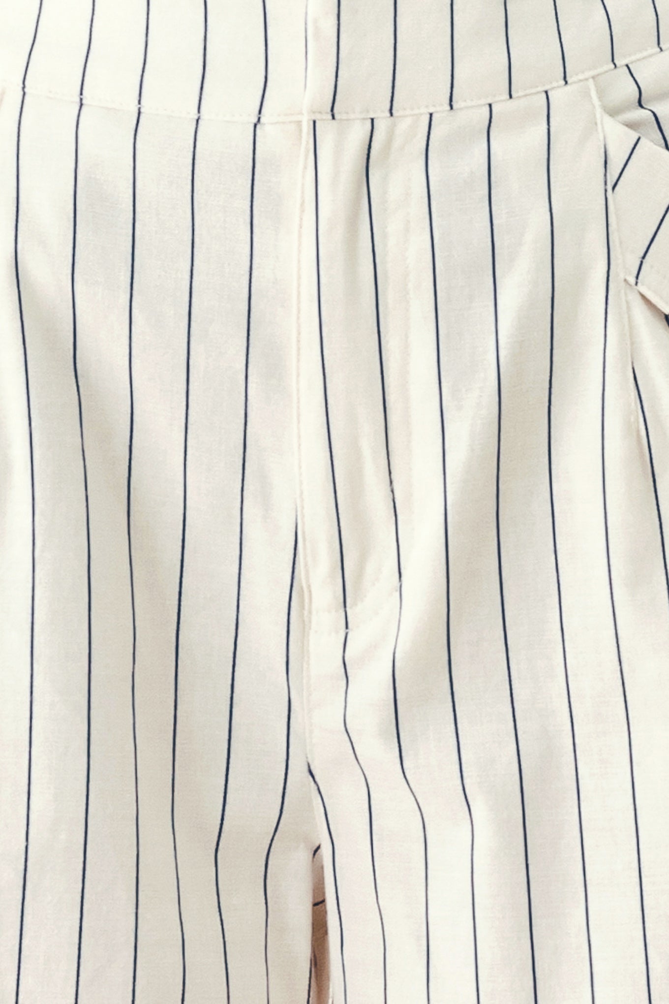 Woman wearing off white pants with thin navy stripes and front pockets | FREEMARKET