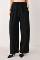 Woman wearing black wide-leg drawstring pants | FREEMARKET