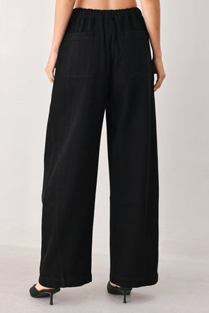 Woman wearing black wide-leg drawstring pants | FREEMARKET