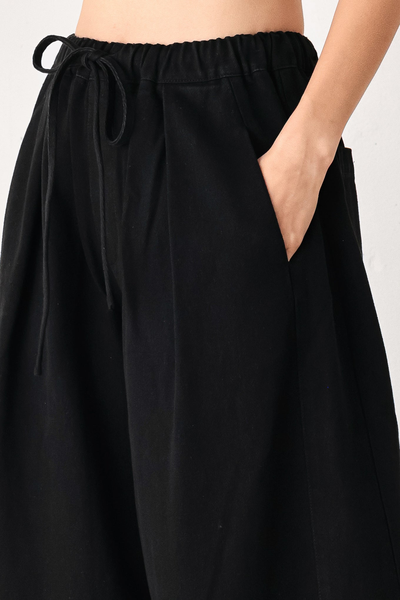 Woman wearing black wide-leg drawstring pants | FREEMARKET