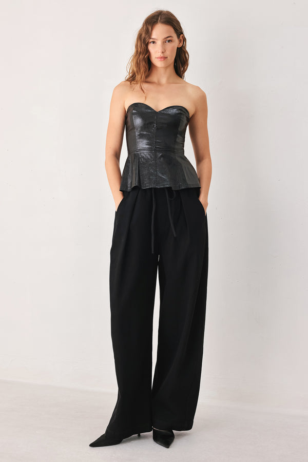 Woman wearing black wide-leg drawstring pants | FREEMARKET