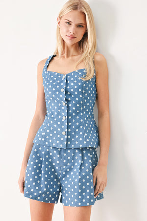 Woman wearing blue polka dot shorts featuring paper bag waist, self waist tie, side pockets and front closure | FREEMARKET