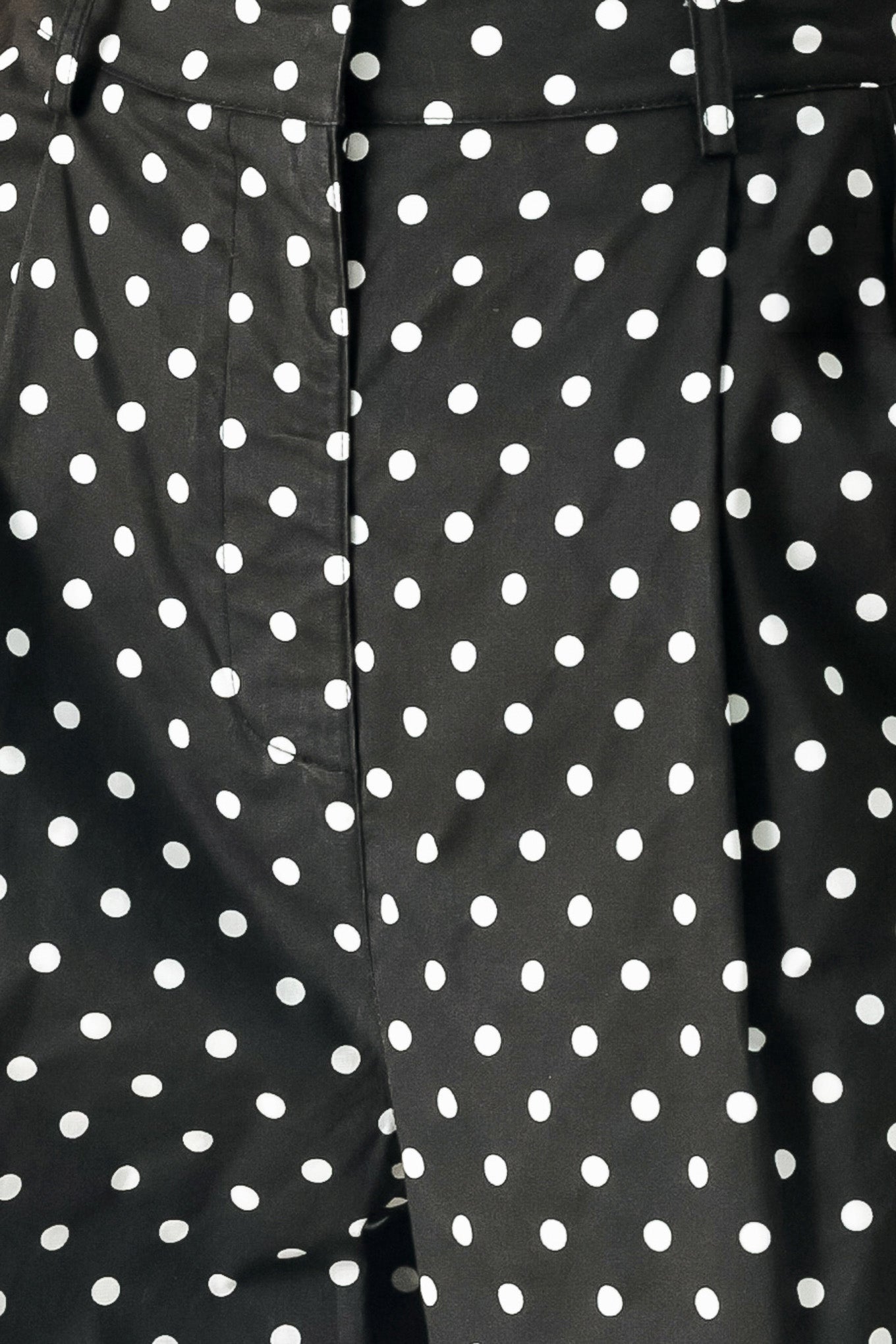 Close up of black polka dot pants with front closure, side pockets and wide leg | FREEMARKET